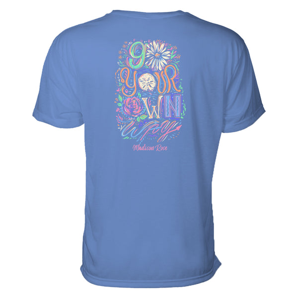 This cute women's t-shirt says "Go your own way" in a painterly fashion with lively pastels complimenting a light blue tee